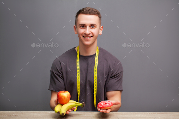 Young sporty physique man holds a high protein meal for good nutrition