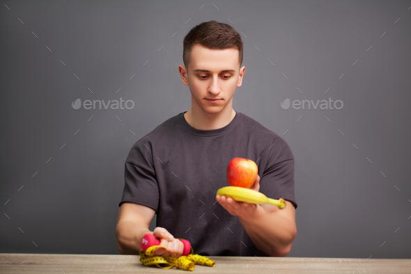 Young sporty physique man holds a high protein meal for good nutrition