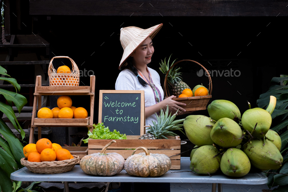 Native Asia woman selling natural variety of fruits at the farm stay