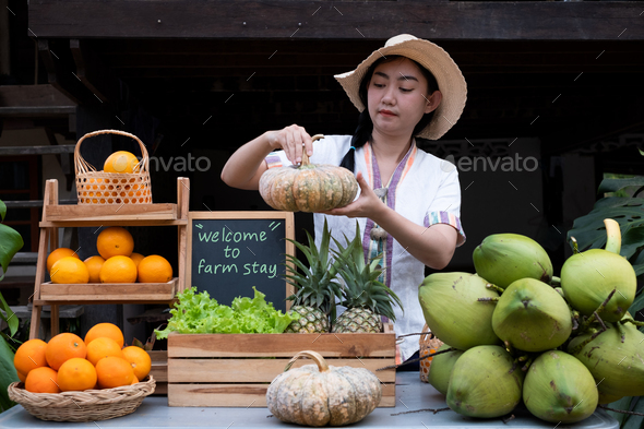 Native Asia woman selling natural variety of fruits at the farm stay