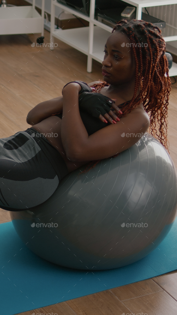Athletic black woman doing morning fitness workout in living room Stock  Photo by DC_Studio