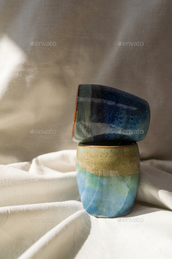 Handmade ceramic cups on the linen fabric - Stock Photo - Images