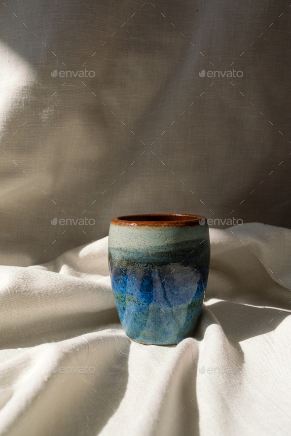 Handmade ceramic cup on the linen fabric - Stock Photo - Images