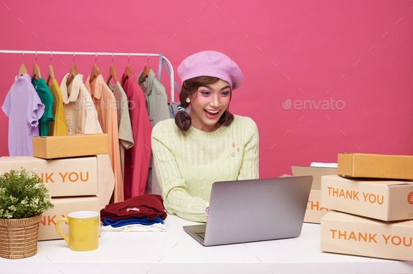 Young asian woman startup small business freelance with parcel box and computer laptop