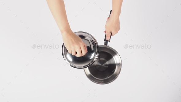 Pot cleaning Man hand on white background cleaning the non stick pot