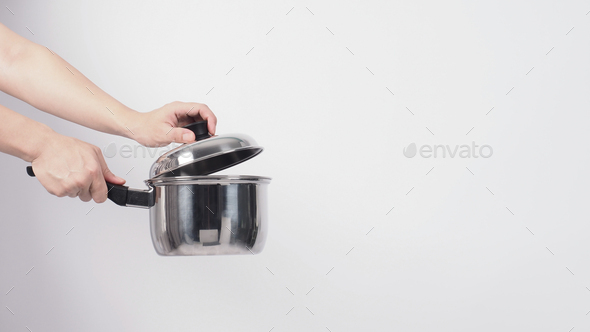 Pot cleaning Man hand on white background cleaning the non stick pot