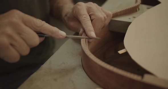 Luthier filing cracks in a guitar mold