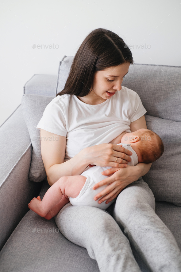Baby breastfeed and sleep on mothers hands Stock Photo by ninelutsk