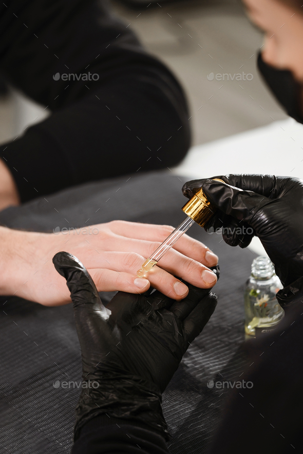 Male manicure. Close up view of the nail service master doing manicure for man