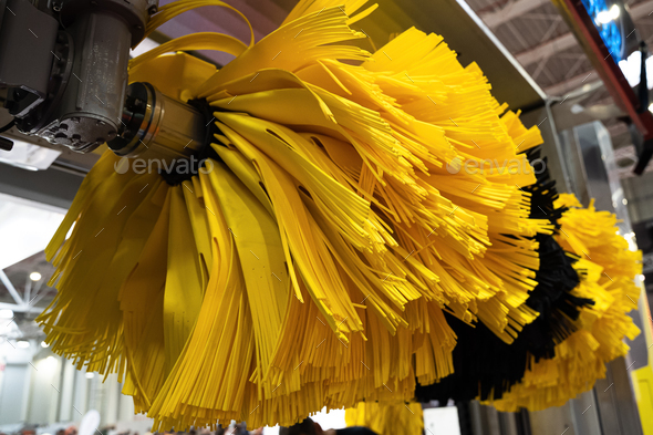 black and yellow automatic car wash system cleaning brushes on spinning rotor in an auto service  - Stock Photo - Images
