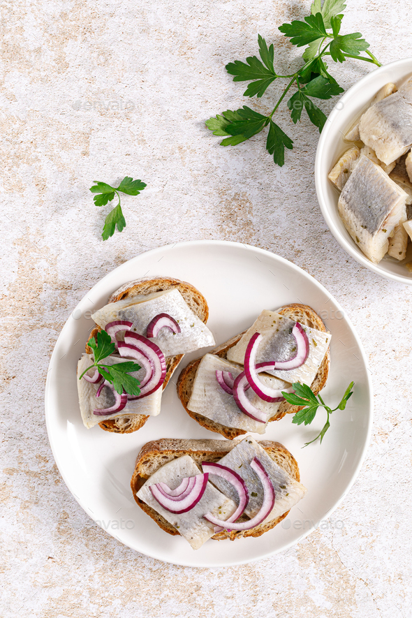 Herring sandwich. Toast with bread, herring and onion. Top view Stock