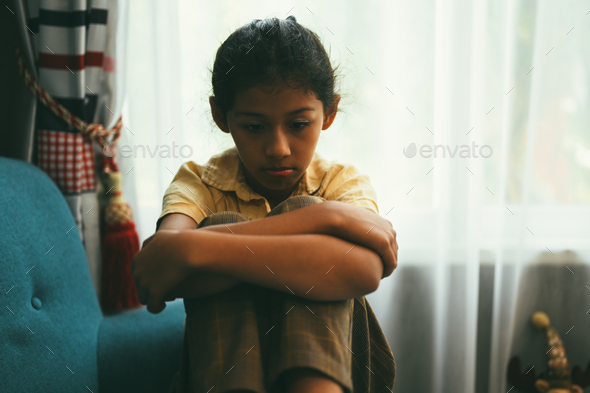 Upset girl hugging knees alone, Concept of lonely girl and kid with trouble