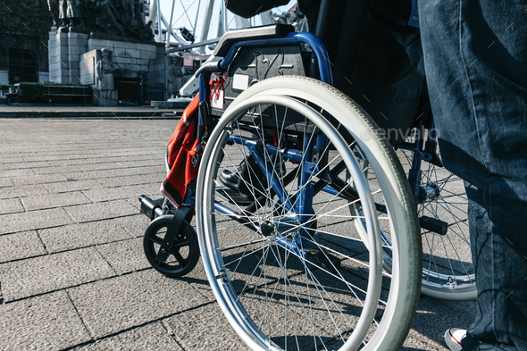outdoors close up of a wheelchair - urban mobility in a disability status concept