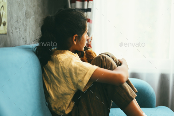 Upset girl hugging knees alone, Concept of lonely girl and kid with trouble