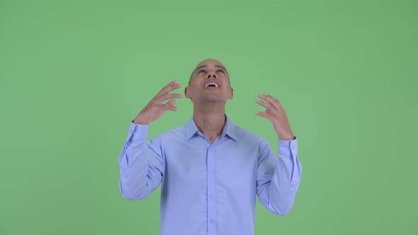 Happy Bald Multi Ethnic Businessman Catching Something alt