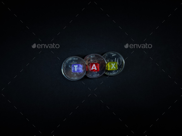 Black bead with color letter in word TAX and coins with black background. - Stock Photo - Images
