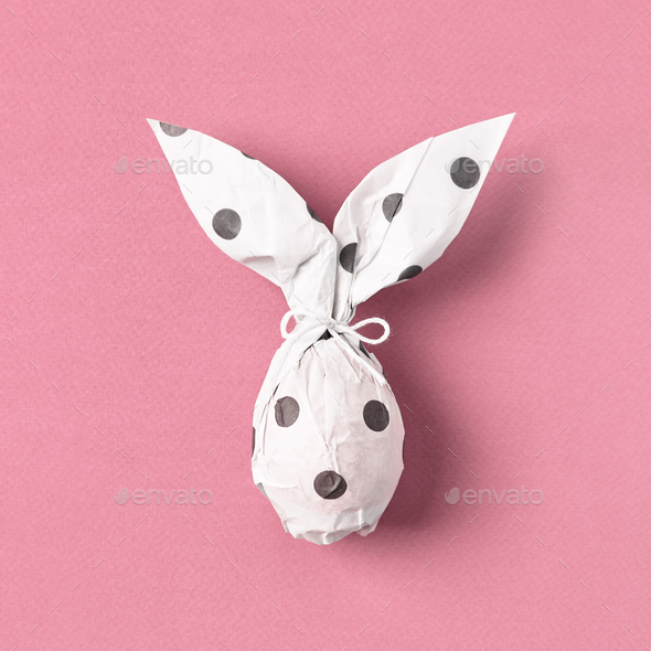 Easter bunny in wrapping paper, DIY gift idea, Easter egg as white rabbit.  Stock Photo by JuliaManga