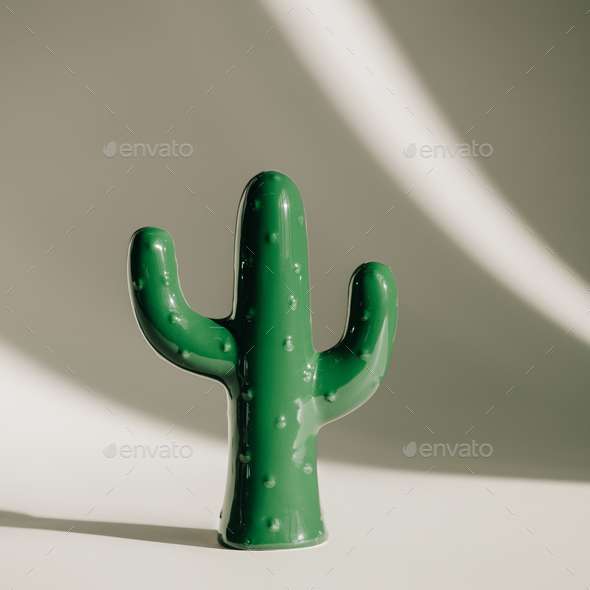 close-up view of green ceramic cactus sculpture on grey Stock Photo by  LightFieldStudios