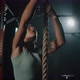 Slow Motion in Gym Girl Jumps Up and Climbs on Rope Wrapping Legs Around It - VideoHive Item for Sale