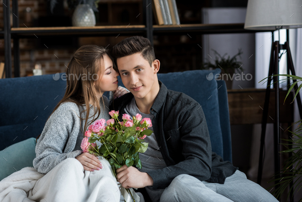 boyfriend presenting bouquet of roses to girlfriend on 8 march