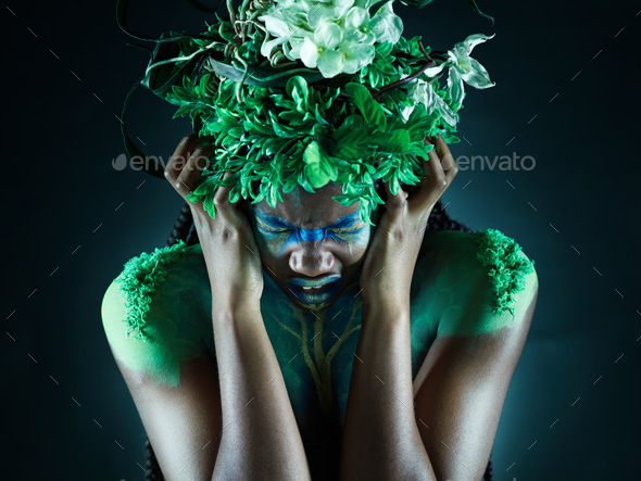 Frustrated, nature and mother earth model feeling sad from climate change in studio. Costume makeup