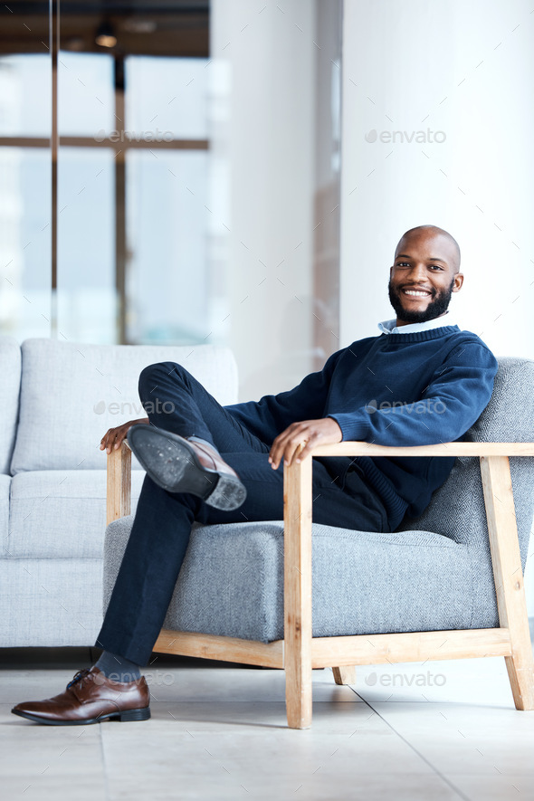 Portrait, black man in office and waiting on chair, smile and confident for job interview, resting