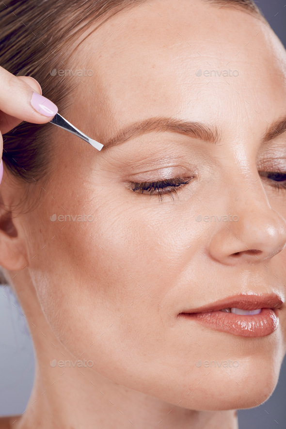 Eyebrow tweezers, face beauty and woman in studio for skincare wellness, aesthetic spa and facial.