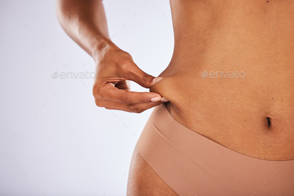 Fat, lose weight and woman touching stomach in studio with liposuction mockup, space and background