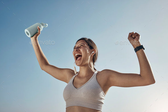 Fitness winner, workout and woman with drinking bottle for achievement outdoor. Excited, smile and