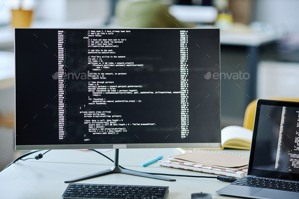 Background image of computer screen with code lines on desk in office ...