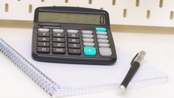 Alarmclock Pen and a Notebook Placed on White Background alt