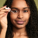 black woman using serum on face - PhotoDune Item for Sale