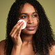 Black woman removing makeup with cotton pad - PhotoDune Item for Sale