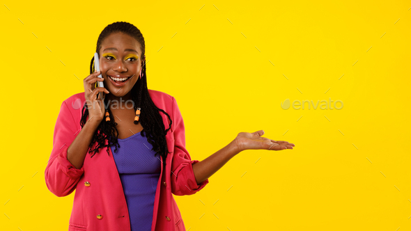 Excited Black Lady Talking On Cellphone Posing On Yellow Background