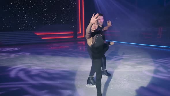 Female Figure Skater Moves to Camera in Arabesquebeautifully Stretching Arm Forward and Making