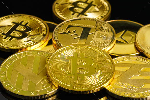 Golden coins with Bitcoin cryptocurrency symbol on black