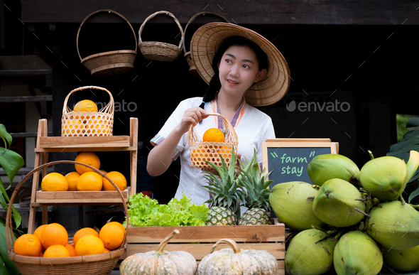 Native Asia woman selling natural variety of fruits at the farm stay, Homestay