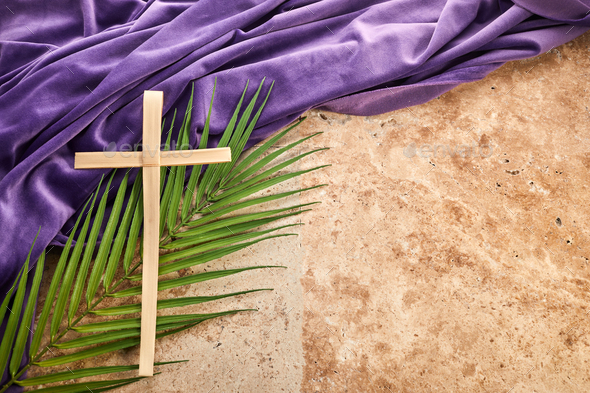 Lent season, Holy week and Good friday concept. Palm leave and cross on stone background
