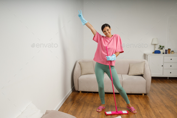 A young woman is cleaning mop living room.