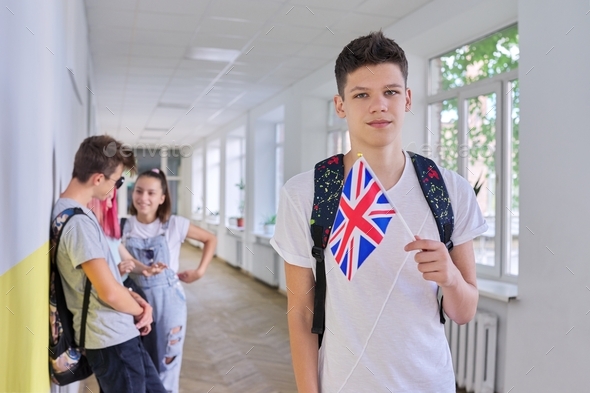 Teenager student with British flag, school corridor group of students background
