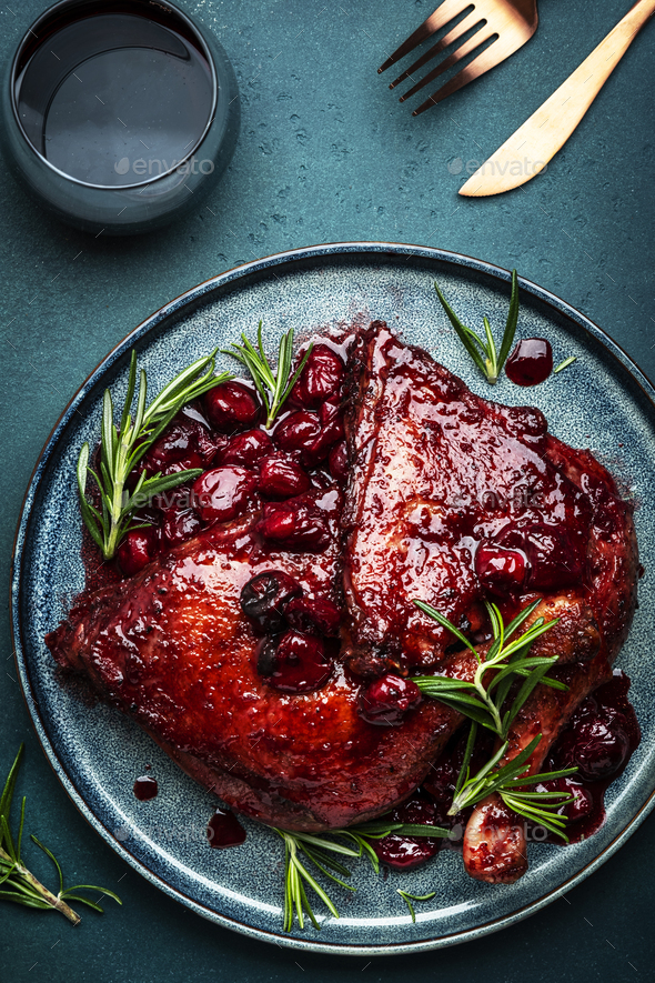 Baked duck legs in cherry and red wine sauce with rosemary. Delicacy