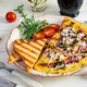 Fried omelette stuffed with sausage, tomatoes, greens and cheese. Delicious easy breakfast - PhotoDune Item for Sale