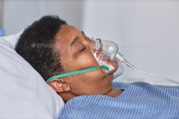Side view of black senior woman with oxygen support mask