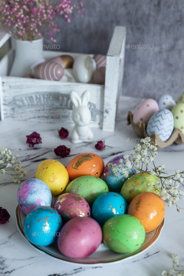 Beautiful multi -colored decorated Easter eggs and a cute white Easter ...