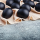 Black Easter eggs on a linen napkin on a blue texture table. Easter celebration concept. - PhotoDune Item for Sale