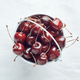 Small white bucket filled with red cherries on light background. Bright sunlight.  - PhotoDune Item for Sale