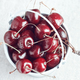Small white bucket filled with red cherries on light background. Bright sunlight.  - PhotoDune Item for Sale