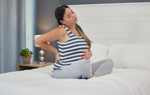 Pregnant, bed and woman with back pain, maternity issues and anxiety with ache, muscle strain and c