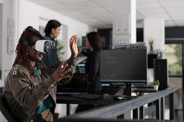 African american system engineer wearing virtual reality goggles