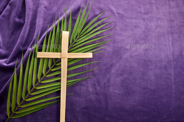 Lent season, Holy week and Good friday concept. Palm leave and cross on purple background